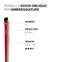 A red angled eyeshadow brush with black bristles, displayed beside Italian text describing it as Pennello area occhi obliquo per ombreggiature 55 for powders, featuring medium-high density.