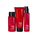 Three red bottles of hair care products, including a shampoo, a Balsamo Ultra Riparatore Senza Risciacquo, and a pump-top leave-in conditioner.