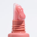 A close-up of a Peptize My Lips - Burro Labbra con Peptidi Volumizzante Idratante tube with a swirl of creamy, peptide-rich product emerging from the nozzle against a light background for an irresistibile effetto rimpolpante.