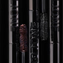 Close-up of glossy Mascara Ciglione tubes embossed with GLIONE. Two wands—dark brown and black—offer effetto laminazione for extra volume and a defined look, all in chic packaging.