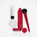 A makeup setting spray, a white tube, a Cipria in Polvere Levigante smoothing powder compact, a small jar, and a powder brush for mature skin.