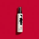 A pump bottle of RICCIOFLUIDO - POZIONE ATTIVARICCI active curl lotion on a vibrant red background.
