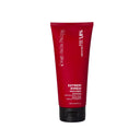 Un tubetto di Maschera Riparatrice, una maschera per capelli danneggiati, in confezione rosso scuro con tappo nero.