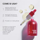 Flacone rosso satinato con contagocce trasparente e gocce di siero per capelli su sfondo bianco.