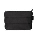 The Beauty pochette nera is a rectangular, padded black zippered pouch featuring horizontal stitching and a small fabric tag on the side.