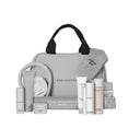 Introducing the Hydrate Please Kit - Routine Viso Edizione Limitata: this gray travel bag with black handles comes surrounded by white skincare products, a gray headband, gray socks, and a gray towel—all branded Diego dalla Palma Milano. This limited-edition set contains everything needed for a complete skincare routine to achieve radiant skin on every journey.