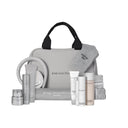 Il kit Time Control - La linea Routine Viso Edizione Limitata di Diego dalla Palma Milano presenta una serie di flaconi, vasetti e tubetti grigi, insieme a una fascia per capelli, un asciugamano, dei braccialetti e una borsa con cerniera e manici, tutti abbinati tra loro: perfetta per la tua routine di cura della pelle anti-età o come kit completo per viso e labbra, il tutto splendidamente esposto su uno sfondo bianco.