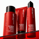Three red bottles of BOND ARCHITECT CPX hair care products, including Shampoo Riparatore, a mask, and a leave-in conditioner, on a glass shelf.