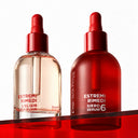 Estremirimedi l’elisir Kit consisting of two skincare bottles with red dropper caps: one clear glass bottle labeled The Elixir and one matte red glass bottle labeled Siero 6.